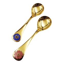Two Danish silver-gilt year spoons by Georg Jensen, the first example decorated with enamel blue cornflower motif, dated 1972, in original pouch, the second example decorated with enamel pink briar rose motif, dated 1976, in original box, each impressed on underside RA AB, Sterling Denmark, and marked for Georg Jensen, together with two further examples by A.Michelson, the first with orange enamel fan design, dated 1965, impressed on underside A.Michelsen Sterling Danmark, TH, the second with enamel family scene, dated 1973, impressed on underside 925 S A.Michelsen Sterling Danmark, B Spang Olsen, approximate gross weight 6.11ozt (190.4 grams)