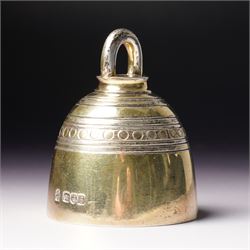 Late Victorian silver gilt table bell with reeded and roundel decoration and loop handle, ...