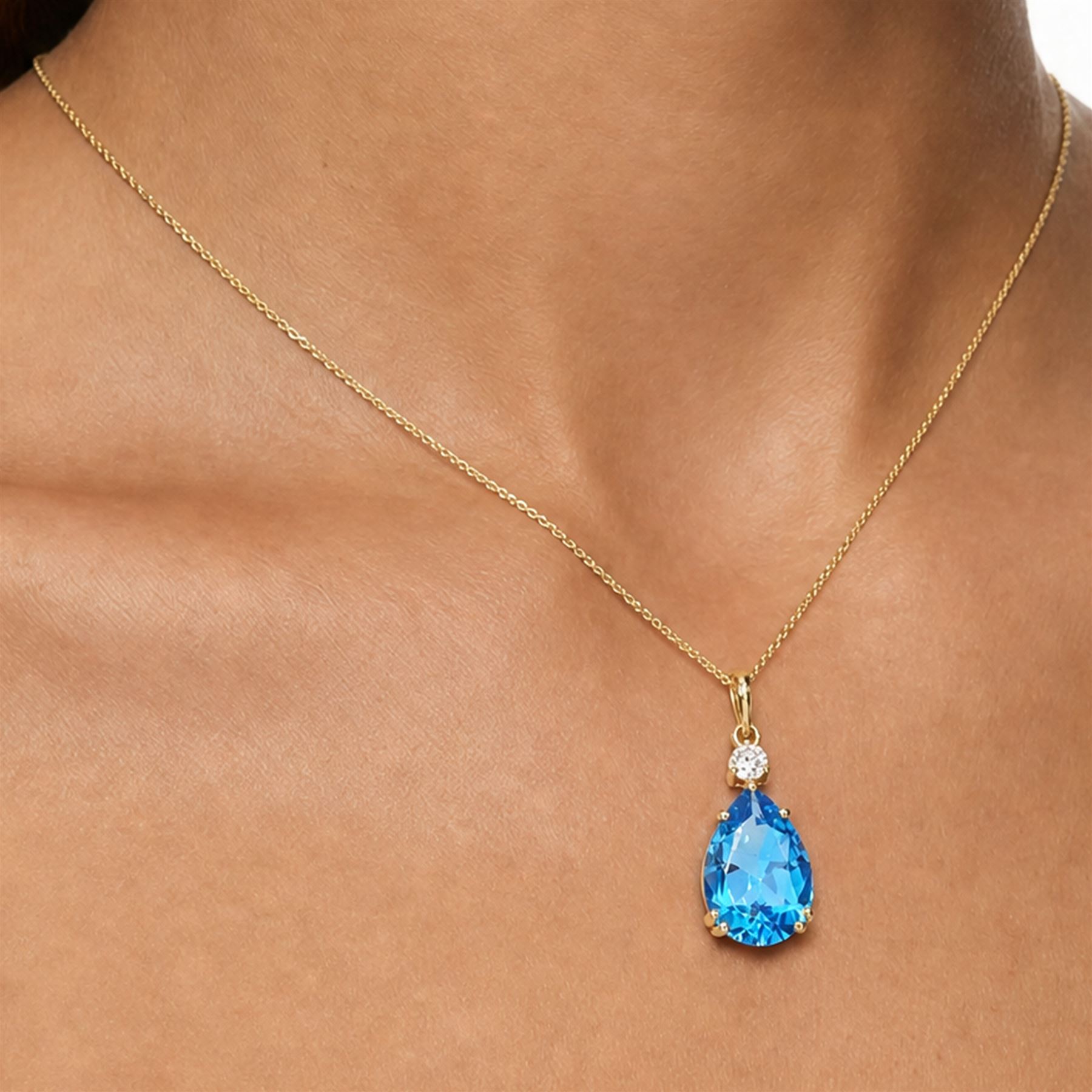 18ct gold Swiss blue topaz and diamond pendant necklace, single pear cut topaz of approx 6.60 carat, suspending from a single round brilliant cut diamond of approx 0.15 carat