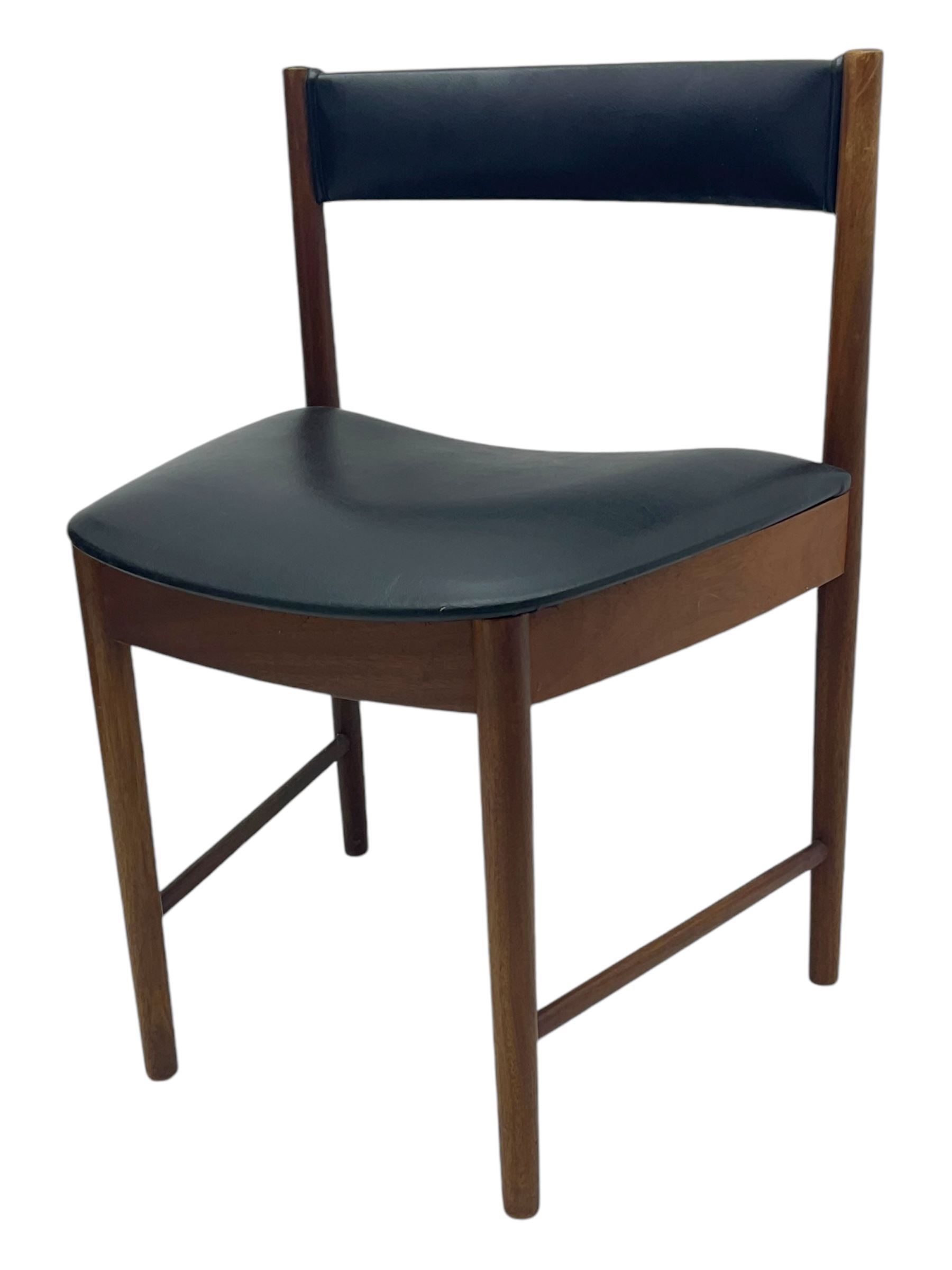 Mid-20th century teak extending dining table, circular top with pull-out extension and concealed leaf extension mechanism, on tapered supports; set of four teak dining chairs with black vinyl padded seats 