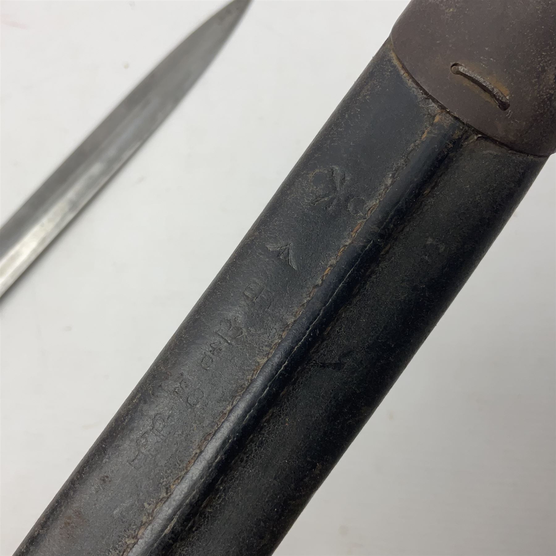 British Pattern 1888 knife bayonet, the 30cm double edged blade by Sanderson with central raised medial ridge and various marks to the ricasso including date code 12 98; in leather covered scabbard with various stamped marks L44cm overall