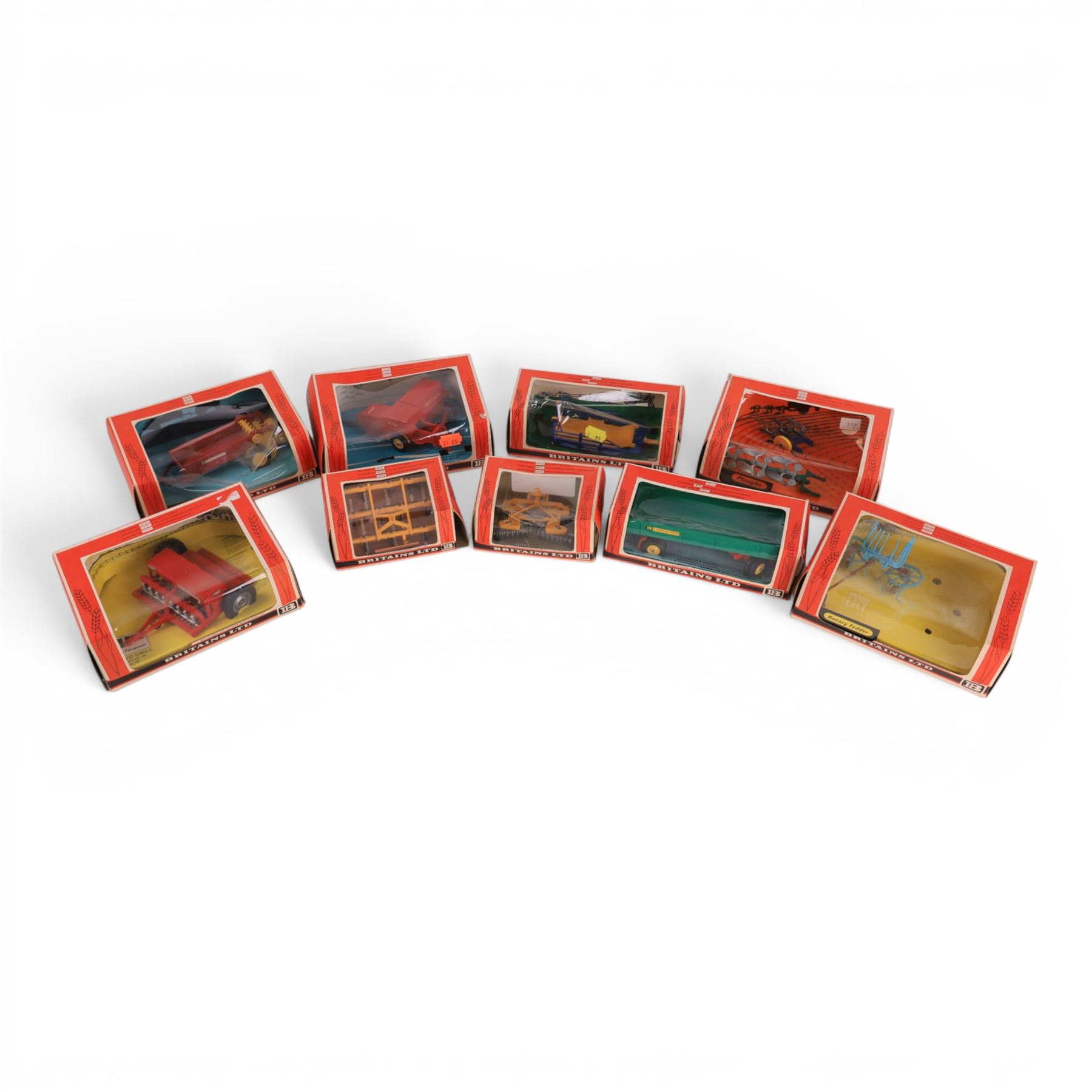 Britains Ltd 1:32 scale farm implements, comprising no. 9556 Hay Baler, no. 9549 Manure Spreader, no. 9553 Disc Harrow, no. 9557 Bale Sledge, no. 9577 Seed Drill, no. 9561 Cultivator Herse, no. 9546 Ploughs and no. 9558 Wheeled Trailer, all boxed