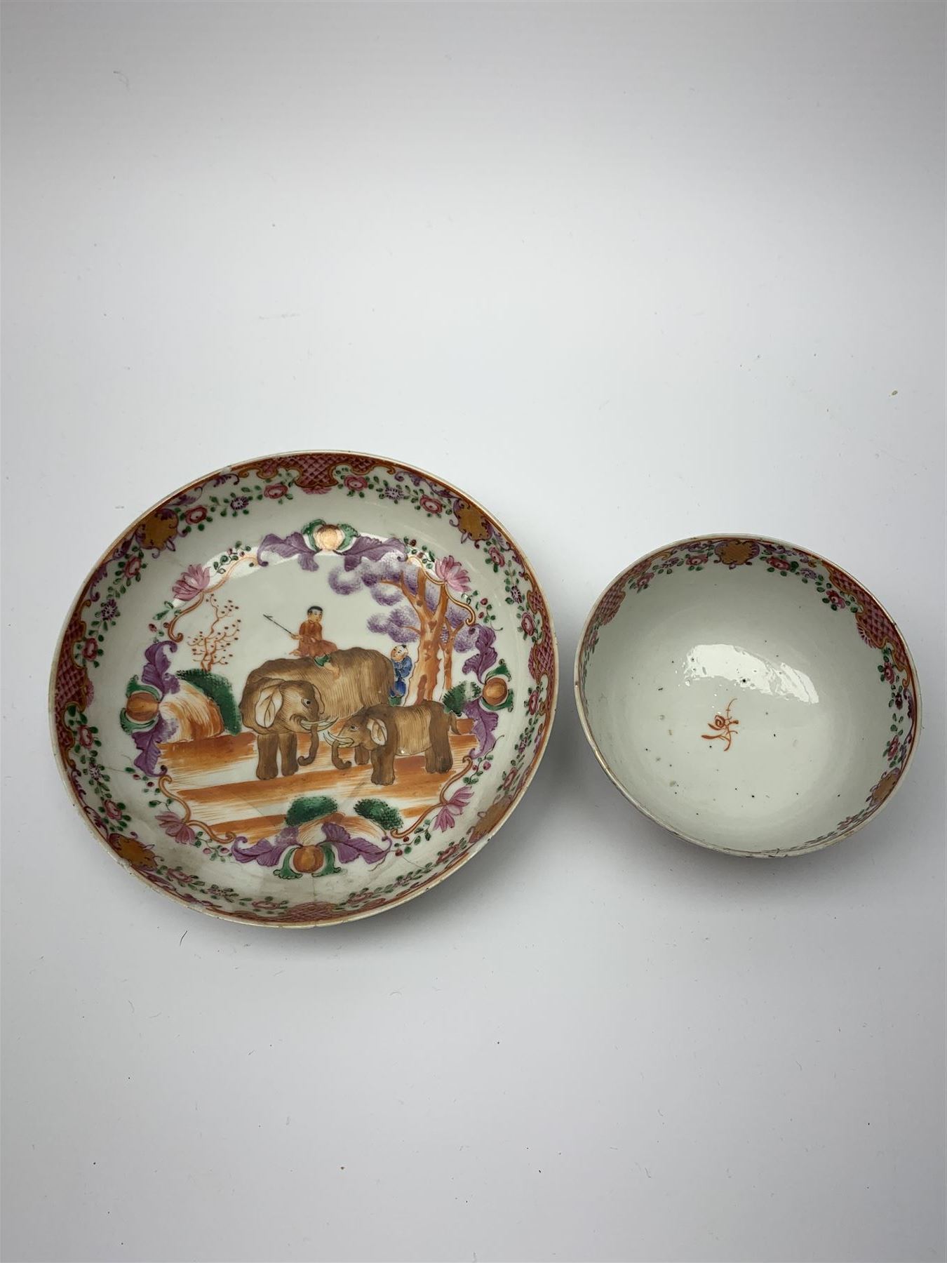18th Century Chinese export tea bowl and saucer, decorated in the Famille Rose pallet with figures and elephants, tea bowl D8.5cm, saucer D13.5cm