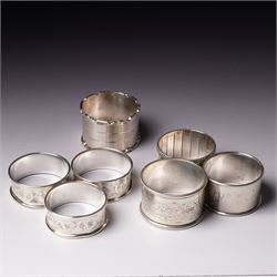 Three engraved silver napkin rings and four others (7)