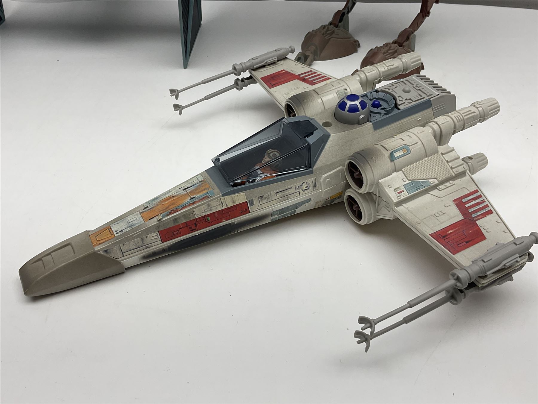 Star Wars - four space/land vehicles comprising Millenium Falcon with hinged top and figures; TIE Fighter; X-Wing Fighter with pilot; and AT-ST 'Chicken Walker' transporter; all unboxed (4)
