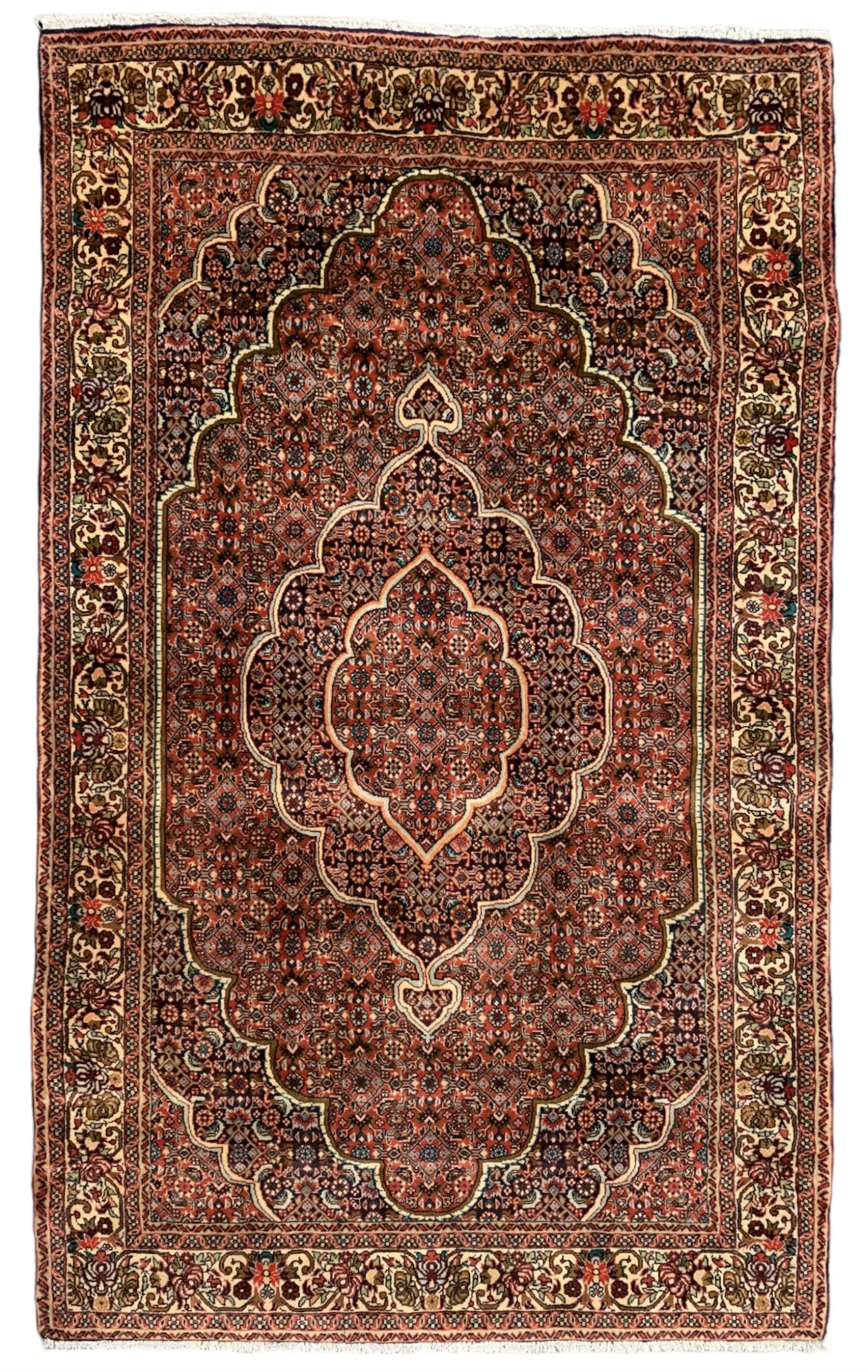 Persian Bidjar crimson ground rug, thick woollen pile, the field decorated with repeating Herati motifs within cusped outlines, the guarded border decorated with repeating flower head motifs