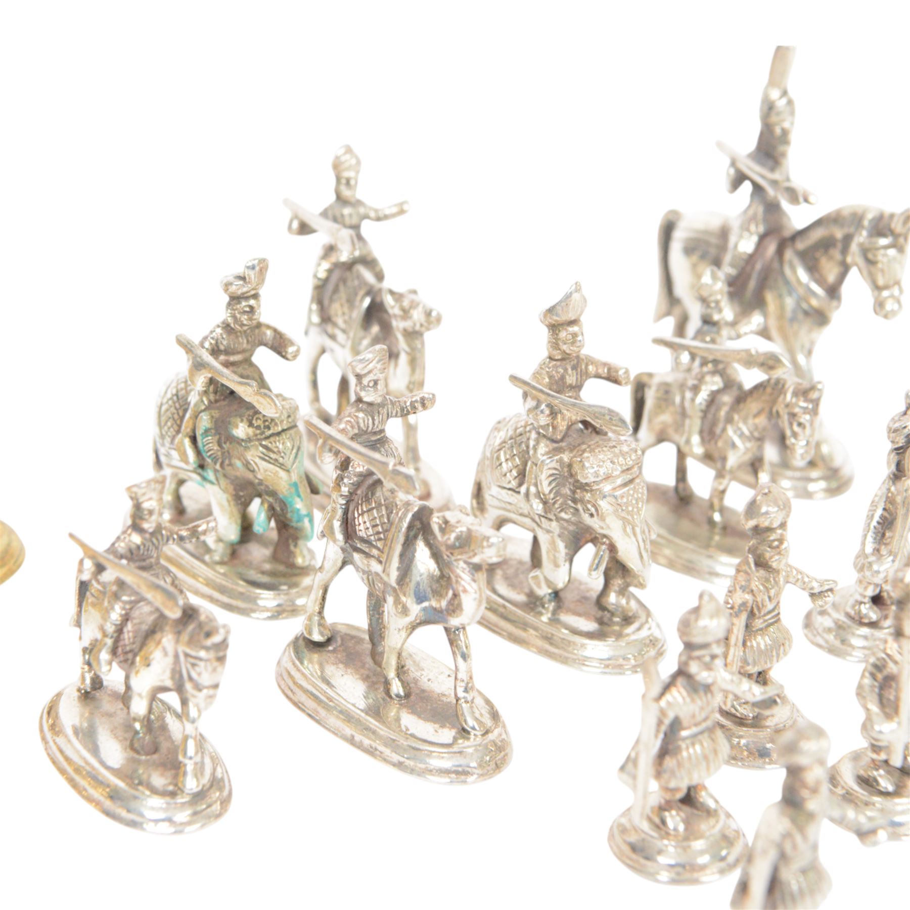 19th century Moghul Indian silver and silver gilt chess set, comprising thirty-two pieces, modelled as soldiers mounted upon elephants, camels and horses with the pawns on foot, unmarked, King H10cm