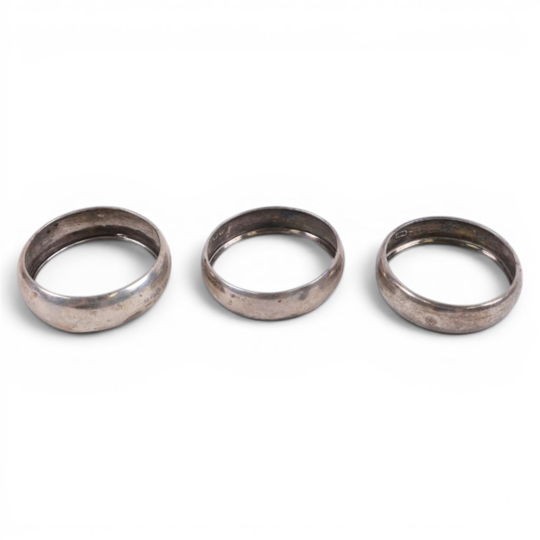 Silver pepper grinder, sifting ladle, silver handled spoon and eight silver napkin rings, all stamped or hallmarked