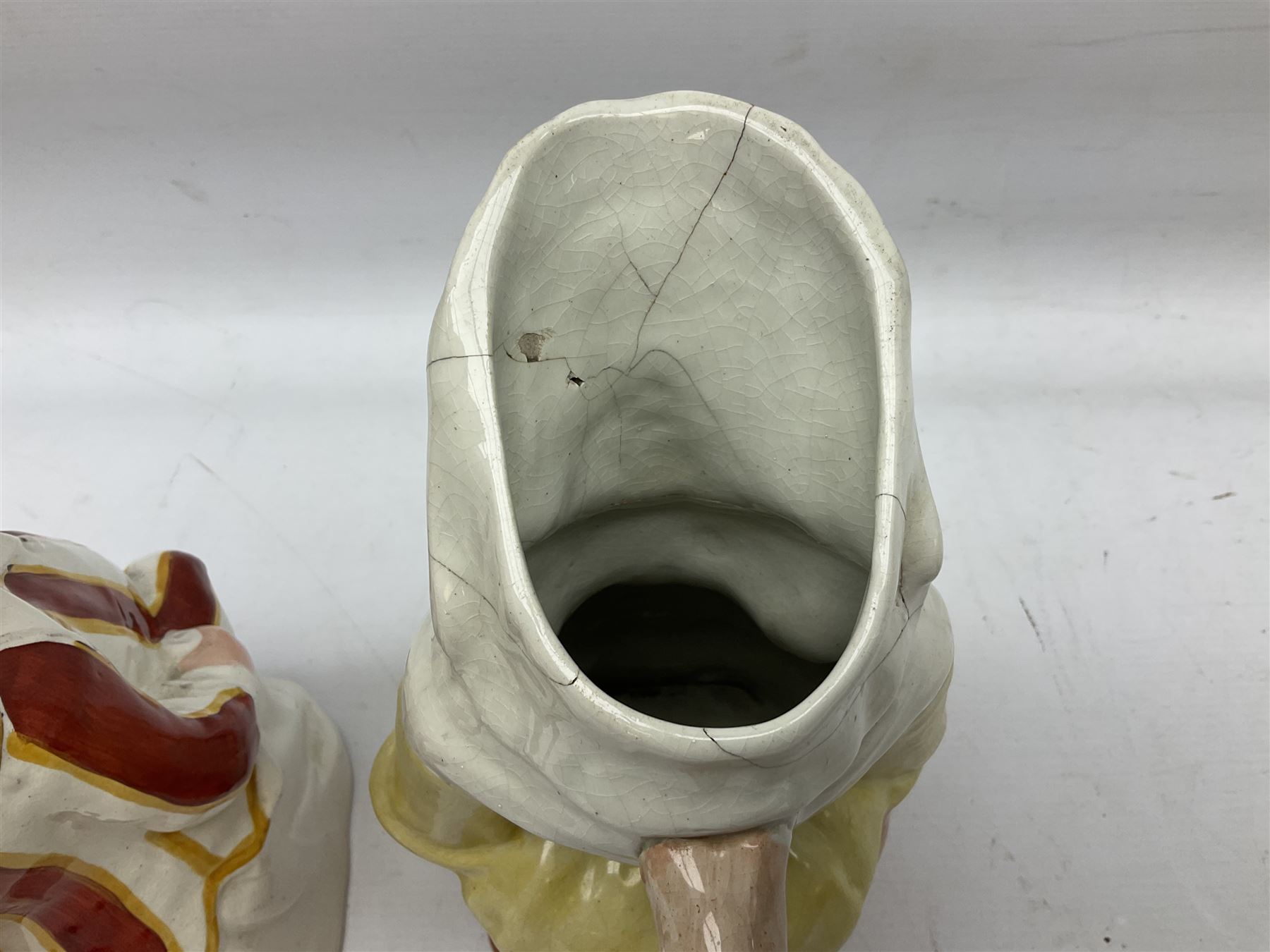 19th century and later Toby jugs comprising Staffordshire Punch and Judy jugs, Victorian 'I am on the black list' jug, two jugs in the form of Toby with a jug of beer (5)