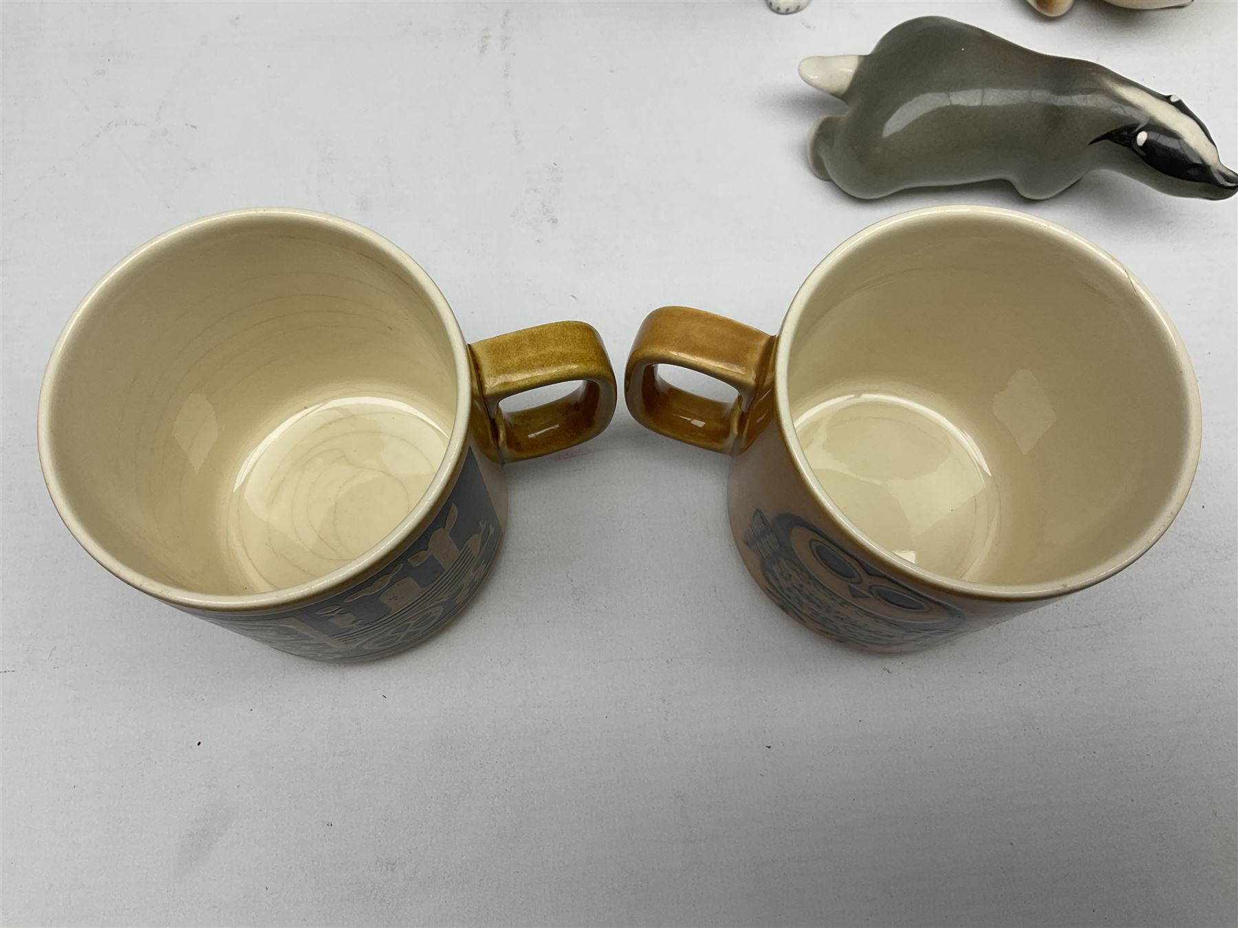 1970's Hornsea mugs, comprising Train Robber pattern designed by John Clappison and Owl from the ‘Newsprint’ Zoo range designed by Jack Dadd, and three USSR figures of animals comprising raccoon, ferret and badger