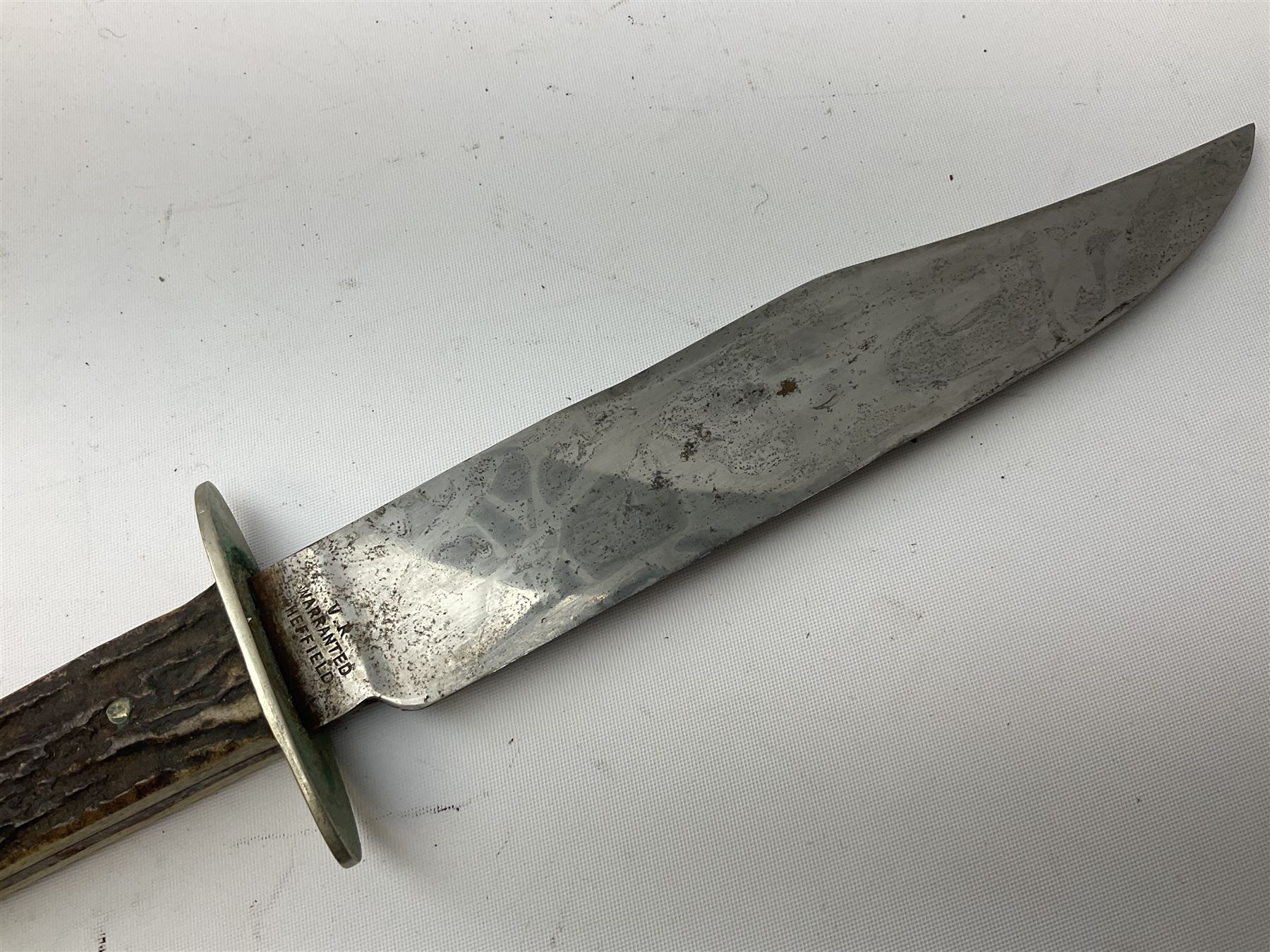 Hunting knife by J Nowill & Sons, Sheffield, the handle inset with mother of pearl, blade length 19cm; George Wolstenholme IXL lock-knife with antler scales L29cm open; and another Bowie style hunting knife marked 'V.R. Warranted Sheffield Joseph Ellis & Sons' in leather sheath (3)