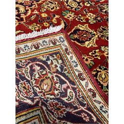 Persian Kashan red ground rug, decorated all over with stylised flower and plant motifs, repeating guarded border