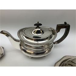 Quantity of silver plate, to include two cruet stands, one example with four cut glass bottles, three piece tea set with oblique gadrooned rims, a further smaller three piece tea set with foliate decoration, knife rests, selection of various flatware, etc. 
