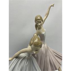 Lladro figure group, 'Merry Ballet', modelled as two ballerinas in dancing pose, raised on a turned socle base, no. 5035, printed marks beneath, H49cm