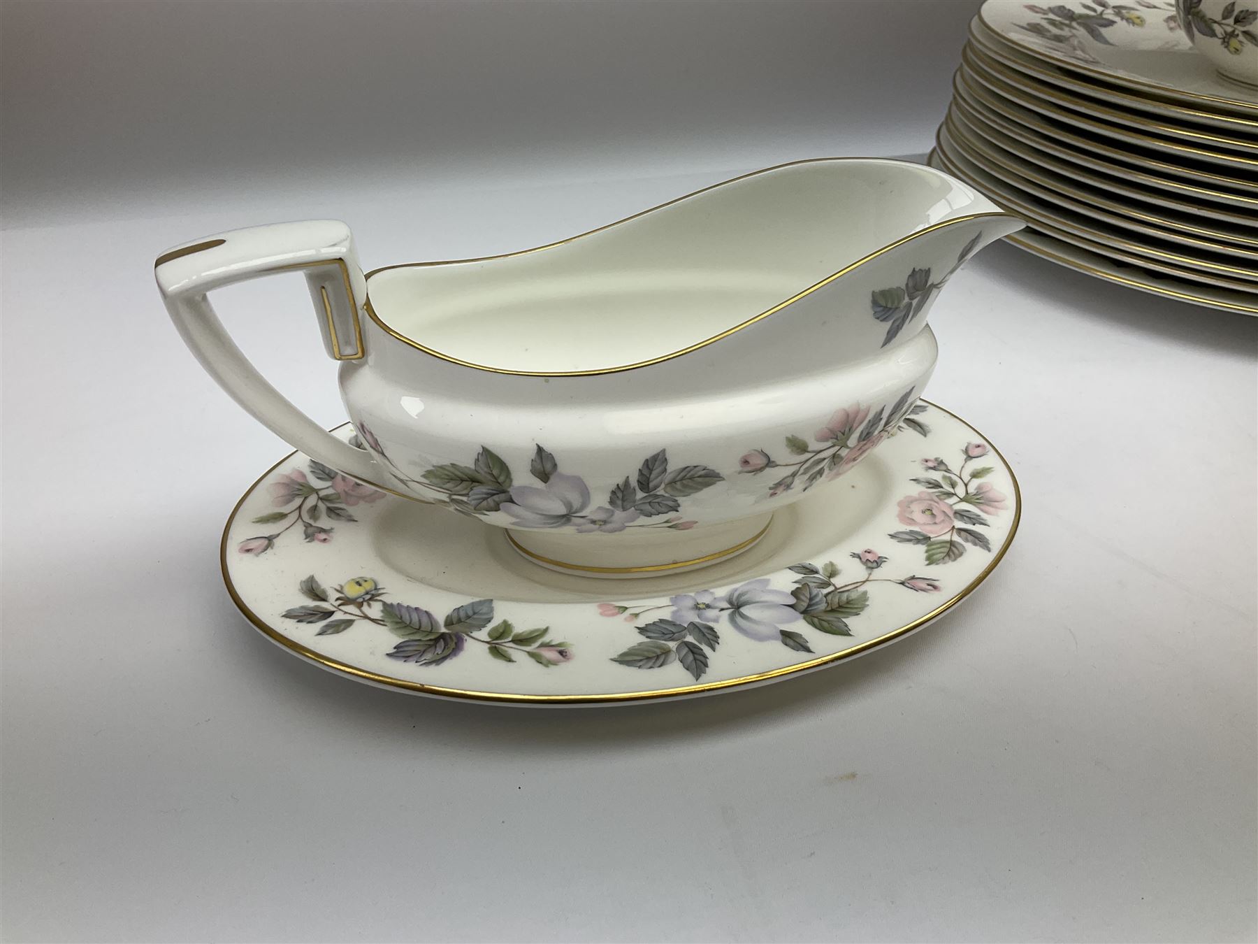 Royal Worcester June Garland pattern tea and dinner wares, comprising thirteen dinner plates, twelve dessert plates, twelve side plates, six twin handled soup bowls and six saucers, six small bowls, sauce boat and stand, thirteen teacups and fifteen saucers, open sucrier, and milk jug