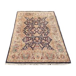 Large Persian design rug, the field decorated with interlacing foliate, the border decorated with plant motifs