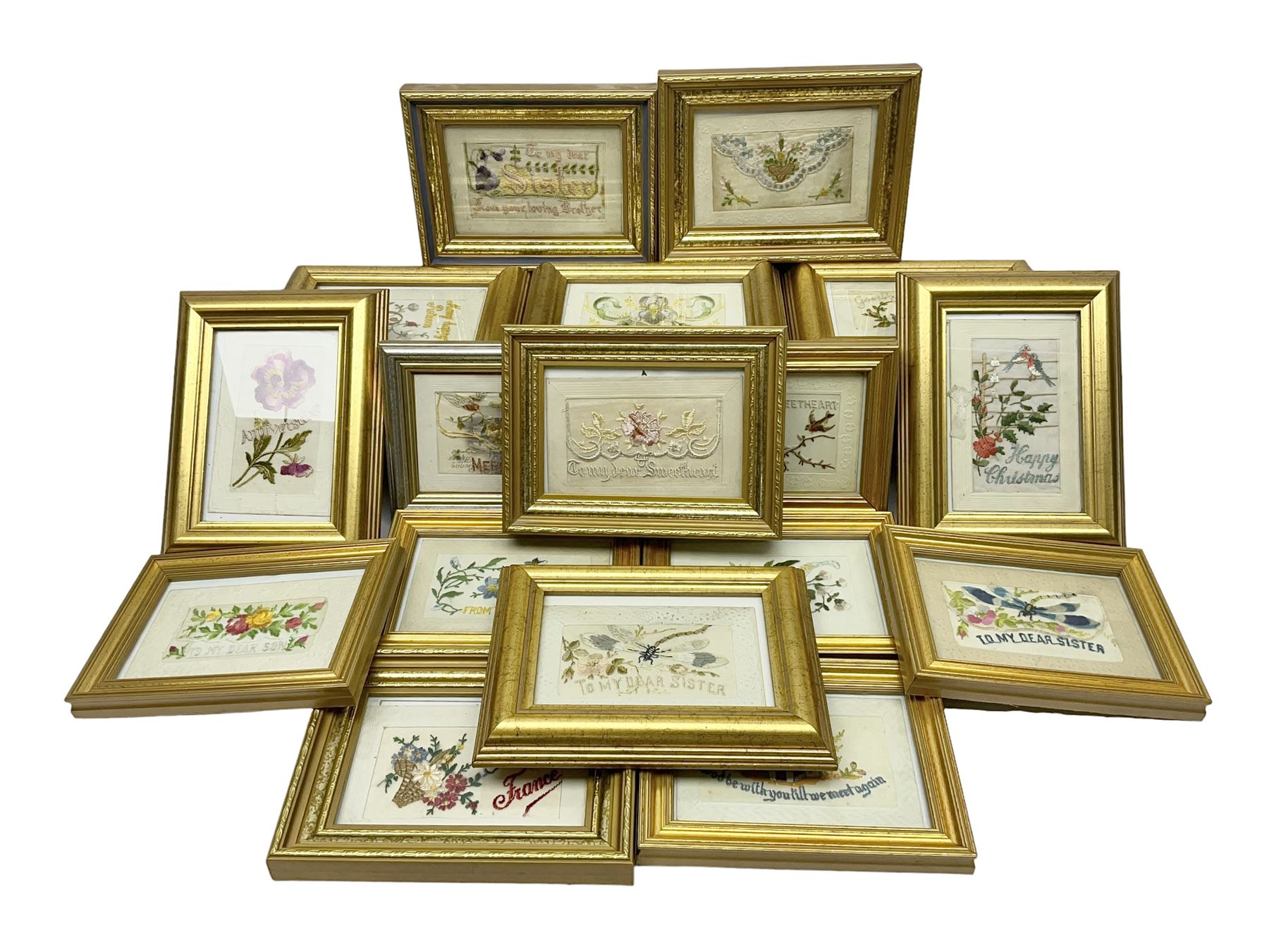 Collection of twenty eight, mostly WWI period embroidered silk greetings cards and postcards, including 'A kiss from France', good luck, sweetheart and Christmas examples, all within modern gilt frames