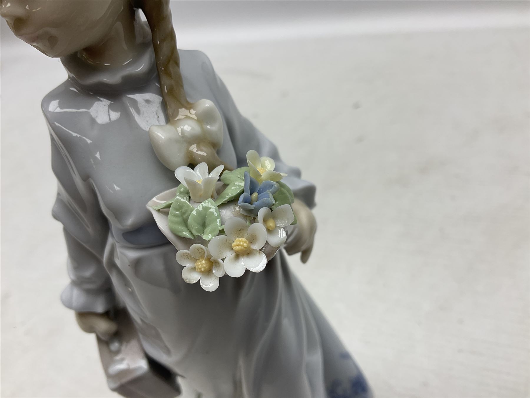 Three Lladro figures comprising, Pocket Full of Wishes no 7650, School Days no 7604 and Spring Bouquets no 7603, all with original boxes, largest example H26cm  