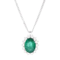 18ct white gold emerald and diamond cluster pendant necklace, single oval cut emerald of a...