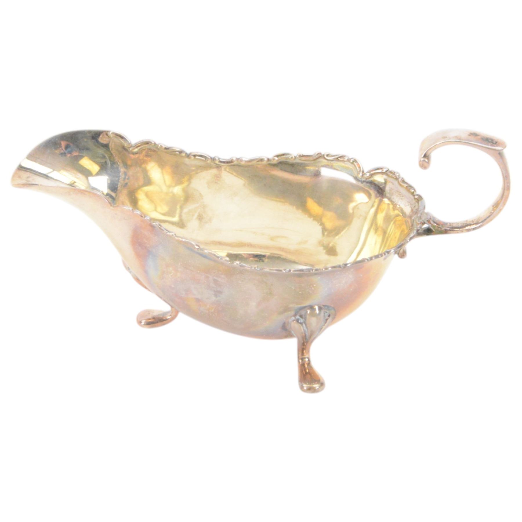 Edwardian silver sauce boat, of typical plain form with shaped rim, with flying C scroll handle and upon three pad feet, hallmarked Birmingham 1907, maker's mark worn and indistinct, together with a pair of Edwardian silver cruets, of urn form, upon three pad feet, hallmarked Horace Woodward & Co Ltd, Birmingham 1905 and a set of six silver apostle spoons, with matching sugar tongs and sugar sifting spoons, some hallmarked Miller Bros, London 1895 and Charles Boynton, all contained within fitted cases