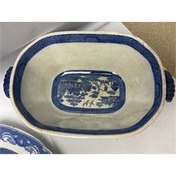Collection of blue and white willow pattern dinnerwares, to include a covered tureen, two meat platters, dinner plates, dishes etc