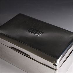 Two silver cigarette boxes, comprising early 20th century plain rectangular example with compartmentalised softwood interior, hallmarked Birmingham 1914, maker's mark indistinct, and an early 20th century example with engine turned decoration and engraved initials to cover, hallmarks worn and indistinct, largest H4.5cm, W21cm