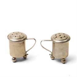 Pair of Swedish silver pepperettes with loop handles, small Middle Eastern silver octagonal salt, unmarked but tests 94 standard, pair of silver gilt and enamel cufflinks and a plated ashtray with golfing motifs