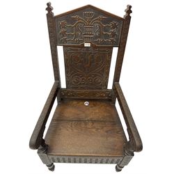 17th century design oak wainscot chair, the back profusely carved with scrolling foliate motifs, the arms carved with repeating guilloche decoration over an arcade apron and turned supports