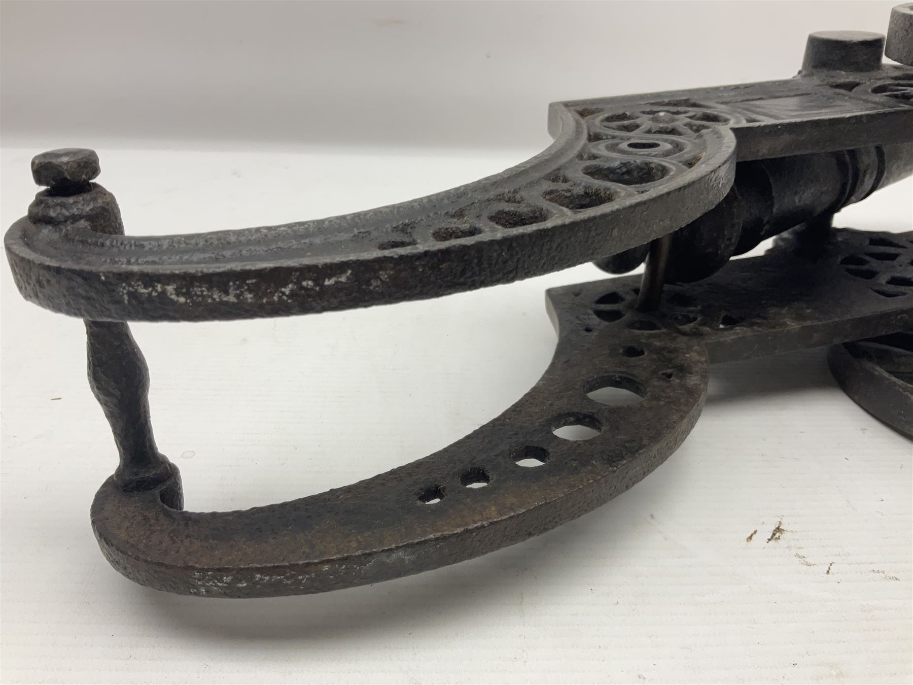 Victorian cast-iron and steel signal cannon, approximately half-inch bore, with 23cm ringed barrel and cylindrical trunnions, on a cast iron carriage with two twelve-spoked wheels and guilloche pierced swept back support, L43cm overall