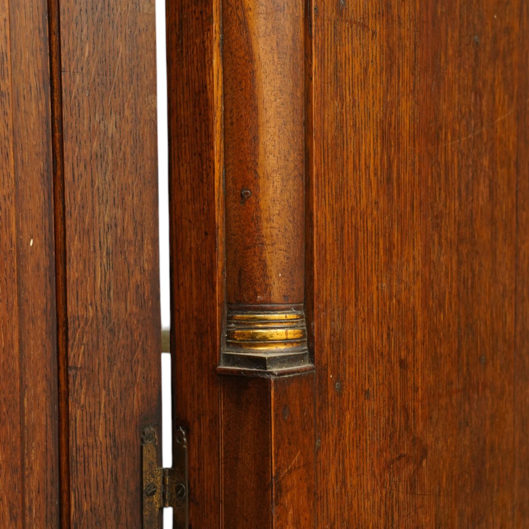 George III oak and mahogany bound enclosed bookcase-secretaire, panelled cupboards over four drawers