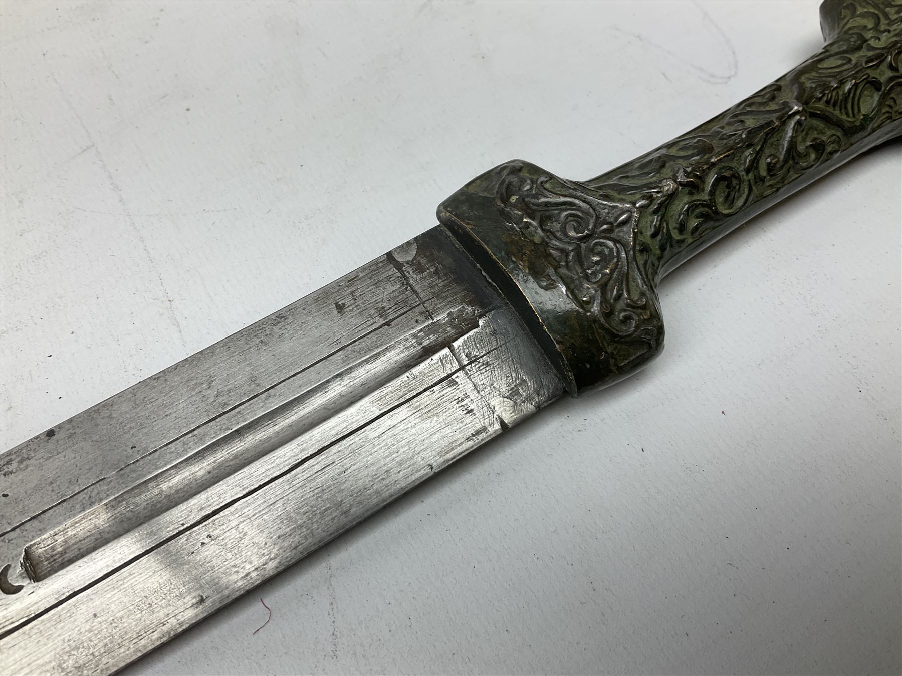 19th century Khanjali dagger, 33.5 cm double edged fullered blade with stamped makers marks, ornate cast grip, with engraved white metal scabbard, 46cm overall