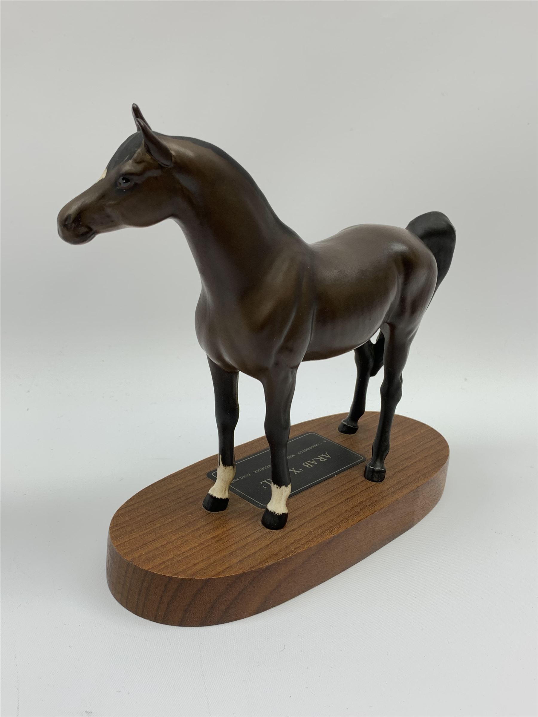 A Beswick Arab Xayal Connoisseur Horse in matt brown, upon a wooden base, together with two Royal Doulton figures, Mystic Bunnykins, and Dusty Dogwood. (3). 