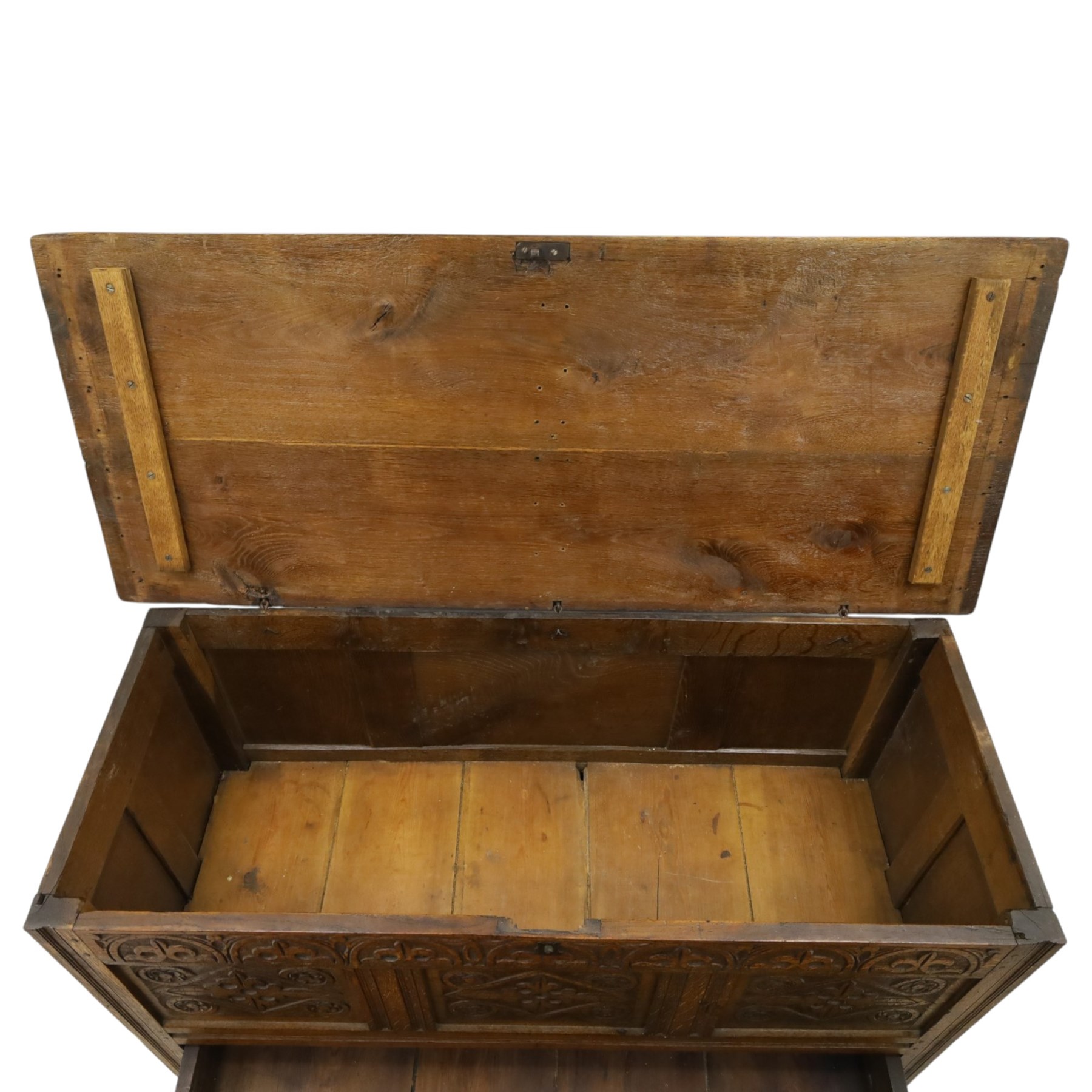 18th century carved oak coffer, rectangular hinged top over a lunette-carved frieze and tracery-style carved triple panelled front, the lower rail carved with repeating anthemion motifs, on square feet