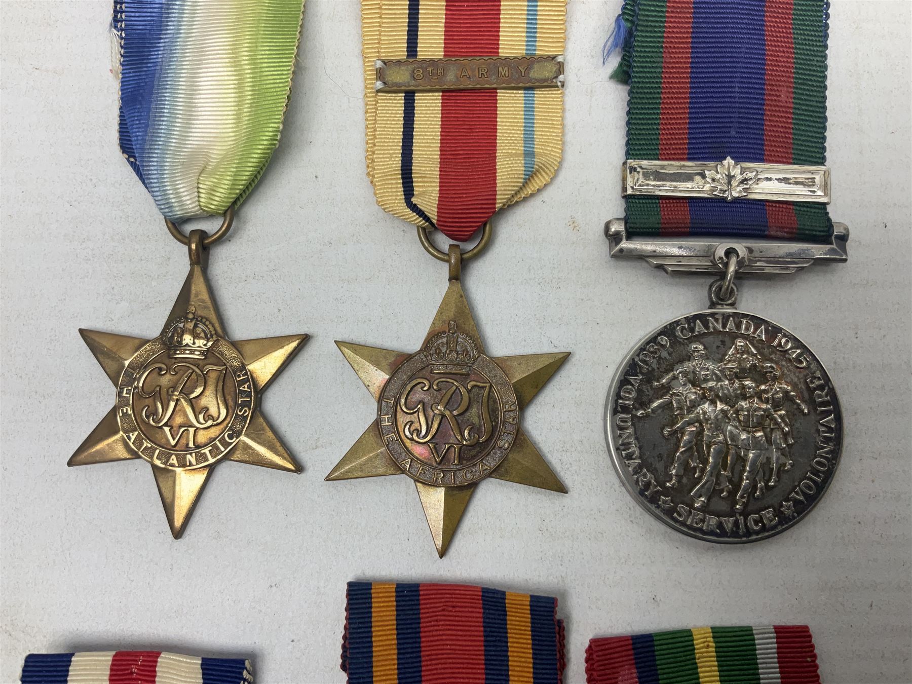 WW2 Canada Volunteer Service Medal 1939-45 with maple leaf clasp; and five WW2 Stars - Burma Star, Atlantic Star, Africa Star with 8th Army clasp, France and Germany Star and Pacific Star with Burma clasp; all with ribbons (6)