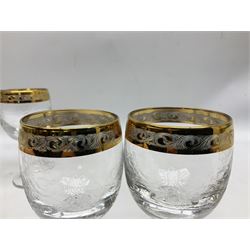 Set of twelve Moser style wine glasses, the bowls with etched floral bodies and gold banded rim with foliate decoration raised upon stem of twisted form, H14cm