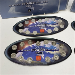 Four 'Canada Millennium 2000' coin sets, each consisting of thirteen commemorative twenty five cent coins on a card display