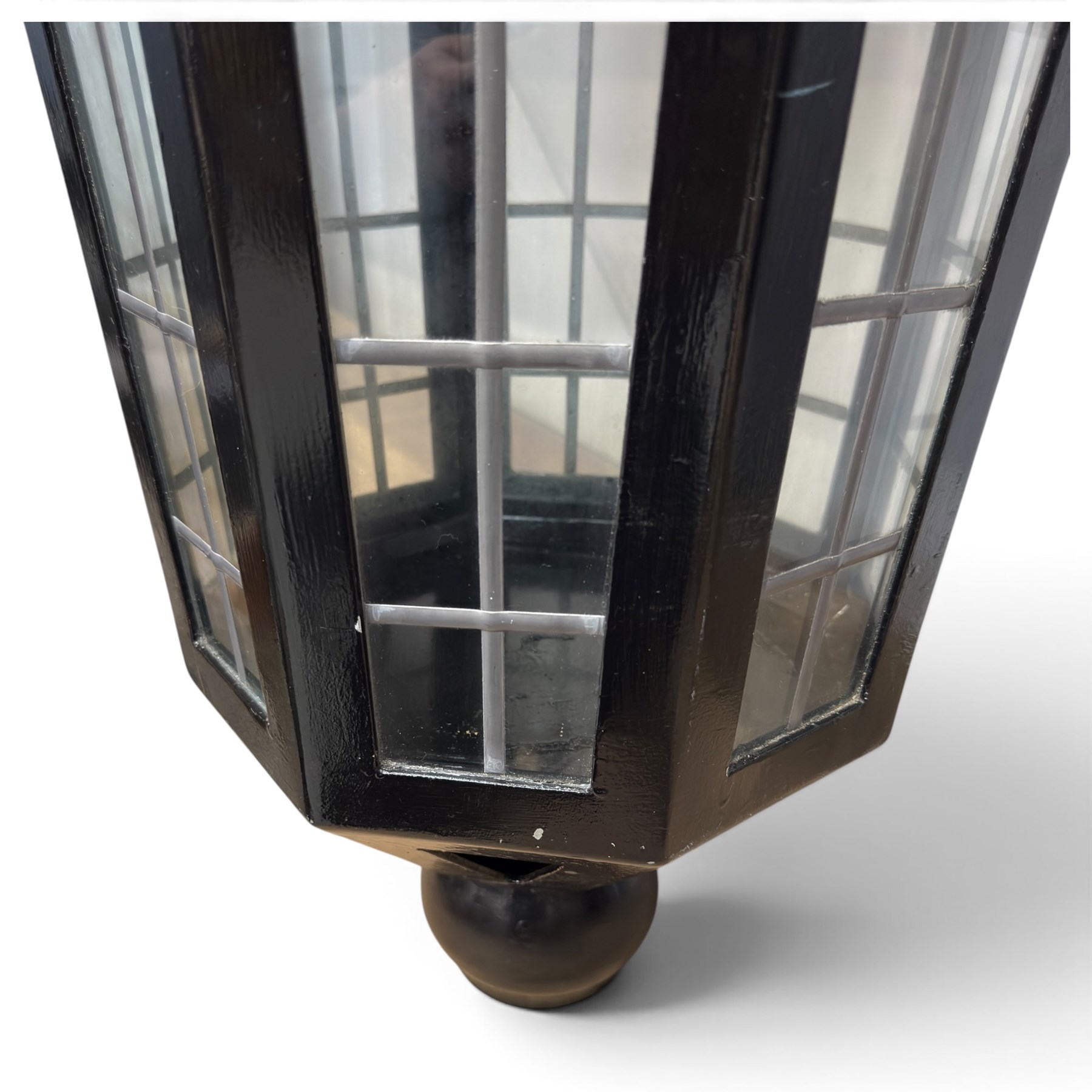 Georgian design black-painted metal octagonal hanging lantern, with brass ball finial above a hipped canopy, astragal glazed lattice panels and pendant ball terminal
