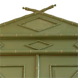 Regency design chinoiserie painted pine armoire, finished in sage green with carved simulated bamboo mouldings, projecting pediment with central lozenge panel, frieze decorated with small lozenges  surmounted by crossed finials, twin doors with diamond-shaped mouldings, interior with hanging cupboard, framed by full-length faux bamboo pilasters, above lower section with two short drawers on post feet 