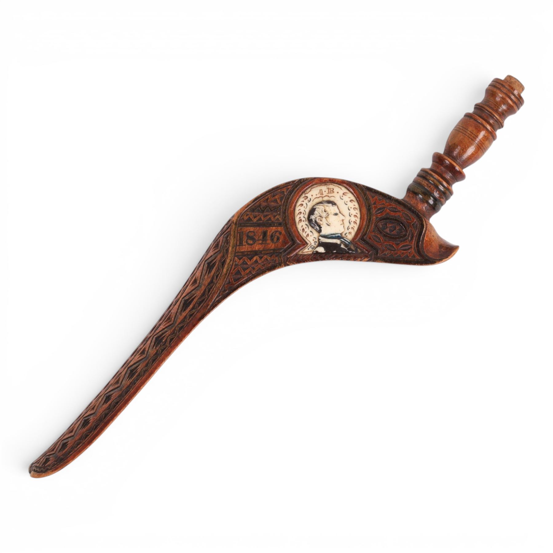 19th Century fruitwood goose-wing knitting sheath, decorated with geometric patterns, with a inset bone bust initialled A.B, together with a carved peg knitting stick, sheath L26cm