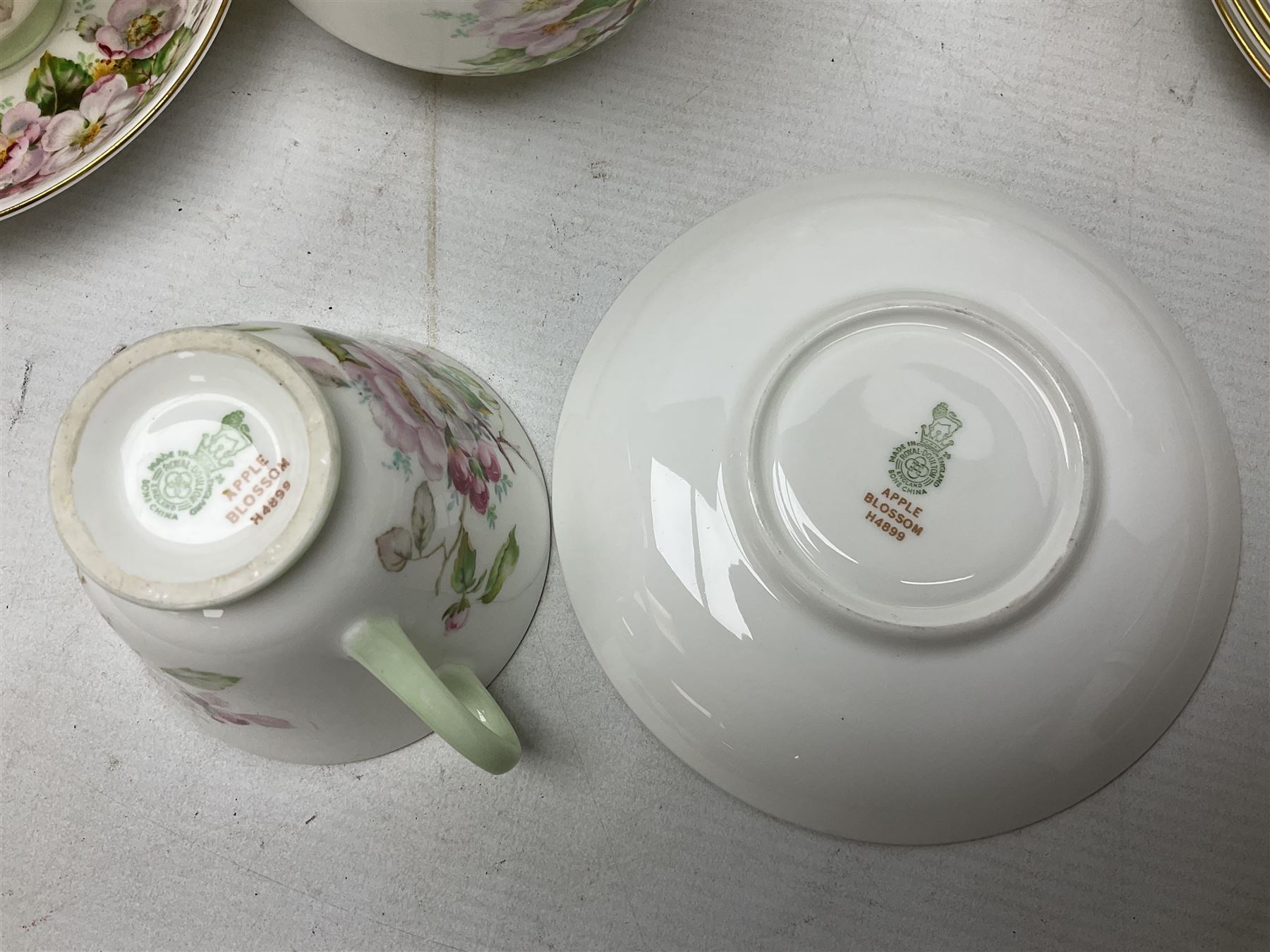 Royal Doulton Apple Blossom pattern tea service for twelve, comprising twelve saucers, twelve tea plates, twelve teacups, milk jug, sucrier and two cake plates