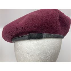 WW2 British Airborne Troops/Paratroopers Steel Helmet with green textured paint finish and netting cover, leather and sponge liner and three point chinstrap mounting; liner marked BMB 1943; together with a paratrooper's maroon beret with metal badge (2)