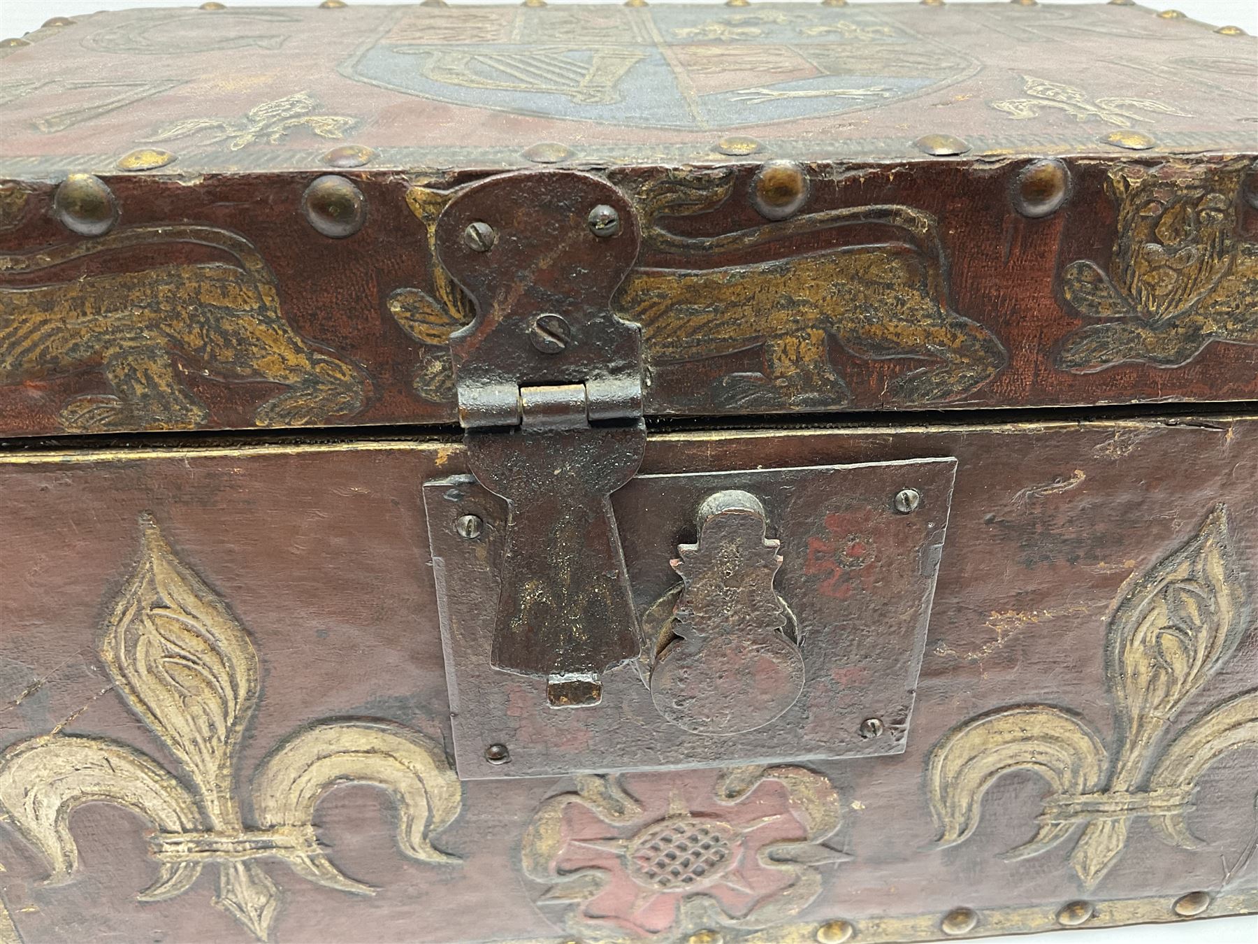 20th century box, decorated in faux leather with the royal coat of arms and GR 1719 to hinged cover, with fleur-de-lis, lion, crown and rose motifs throughout and studs to all edges, opening to reveal a purple velvet interior containing three removable wooden trays, H18.5cm