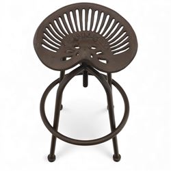 Industrial design pair of cast metal 'tractor seat' revolving bar stools, each with pierced tractor seat shaped top from the early 20th century, raised upon tubular steel supports with circular footrests (Height adjustable from 77cm - 93cm)