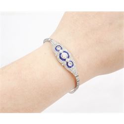 Art Deco platinum diamond and sapphire target design bracelet, five old cut diamonds, surrounded by calibre cut sapphires and old cut diamonds, all milgrain set, to a graduating old cut diamond and polished articulated rectangular link bracelet, the sides with engraved foliate decoration, French import mark, principal diamond approx 0.45 carat