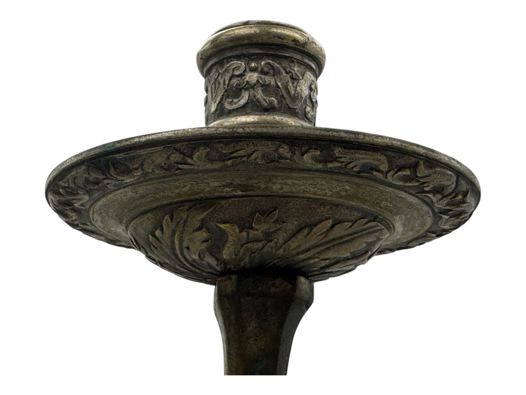 Early 20th century cast brass chandelier, the main baluster-form body surmounted by a lobed finial, with three cherubic heads and foliate scrollwork around the upper section, eight sweeping branches for lights