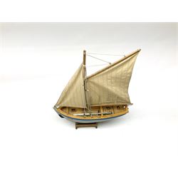 Wooden model of RMS Titanic, on a fixed black stand bearing plaque inscribed 'Titanic 1912', L54cm, H22cm, together with model of a sloop, gaff rigged on stand bearing plaque inscribed 'Sloop' L32cm, H42cm; and model of a fishing trawler on a stand bearing plaque inscribed 'Chalutier' L35cm, H28cm (3)