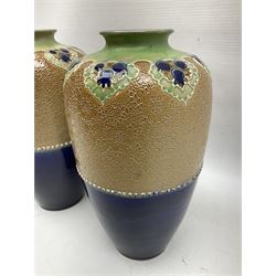 Pair of Royal Doulton Lambeth stoneware baluster vases, decorated in light relief with foliage, impressed mark beneath, H23cm