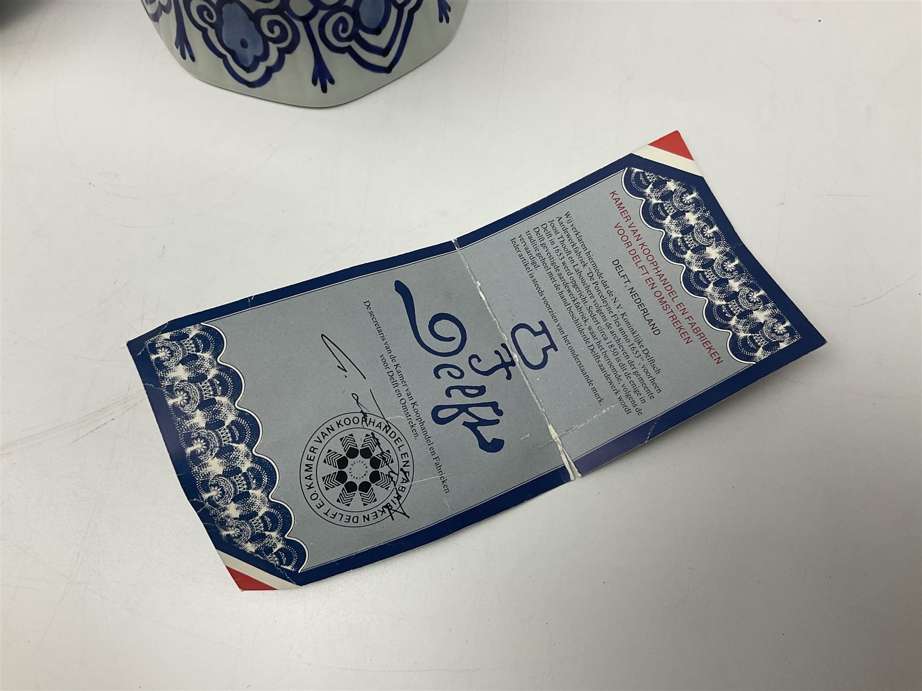 De Porceleyne Fles Delftware blue and white covered jar, of fluted baluster form, with floral and insect decoration, upon an octagonal foot, the octagonal cover with urn shaped finial, H32cm