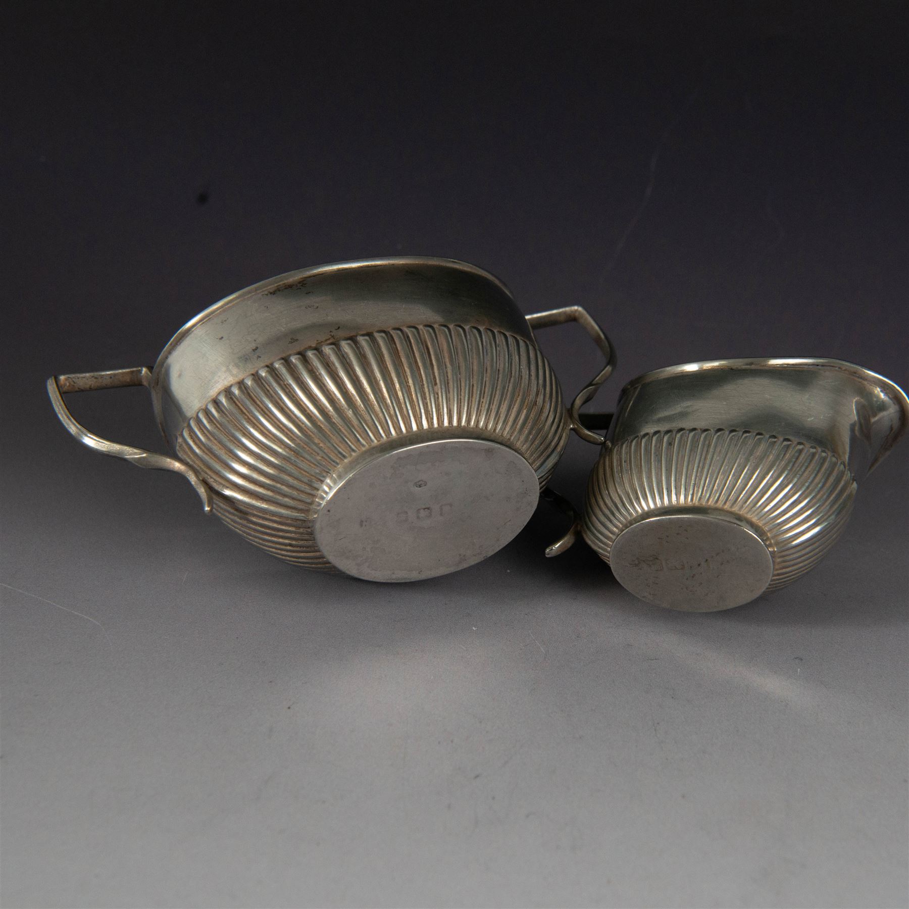 Early 20th century silver milk jug and open sucrier, each of oval part fluted form, hallmarked Birmingham 1911, maker's mark worn and indistinct, H7cm