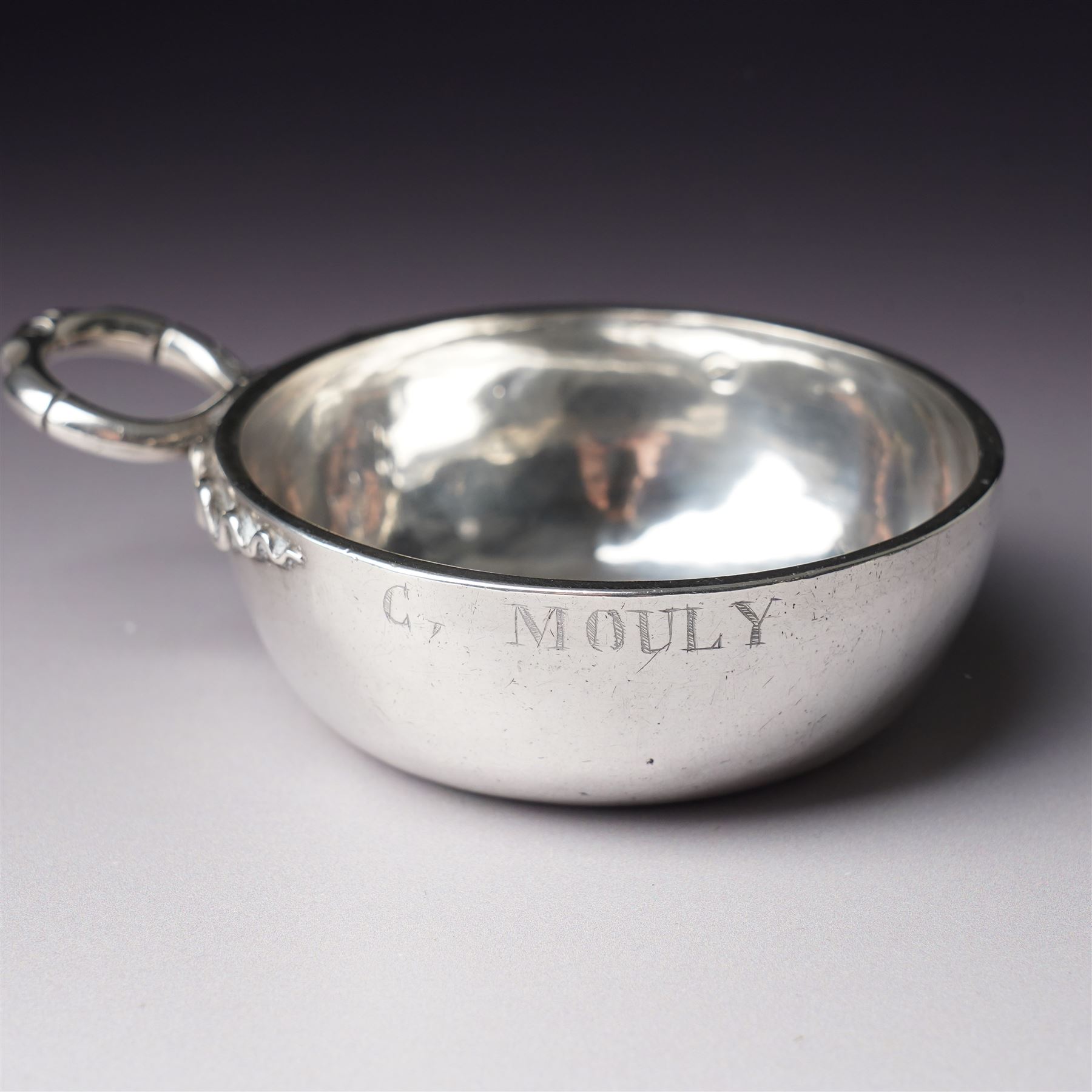 French silver tasse de vin with Minerva's head and makers mark J.P. with an anchor, the rim engraved C Mouly, Spanish tasse de vin inset with a silver coin and two other tasse de vin (4)